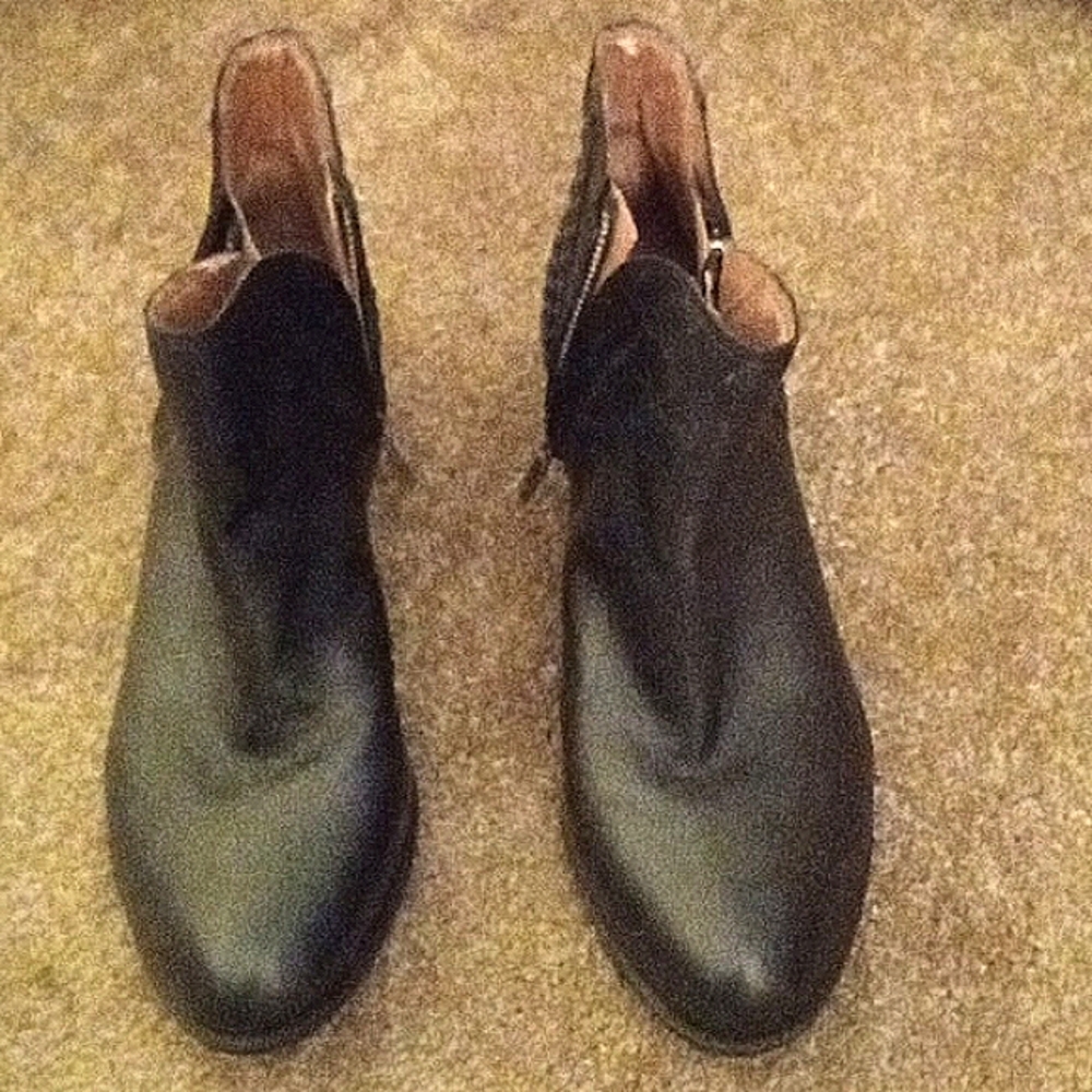 Black ankle boots with design on the heels, side zippers on both sides of boots.